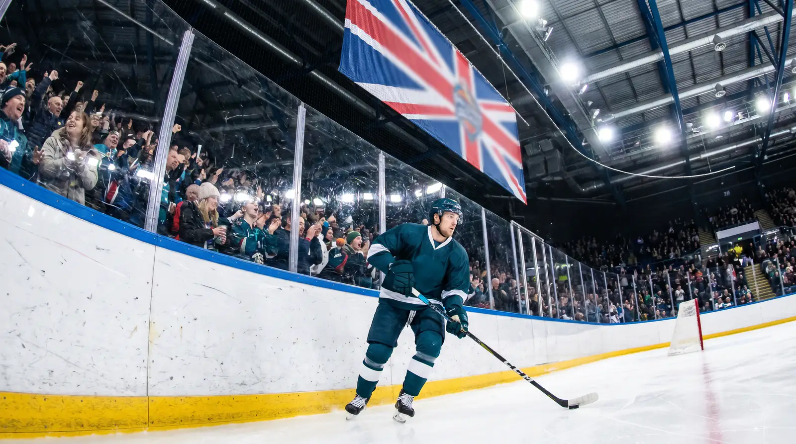 Belfast Giants-style forward skating during a home match at SSE Arena with crowd packed
