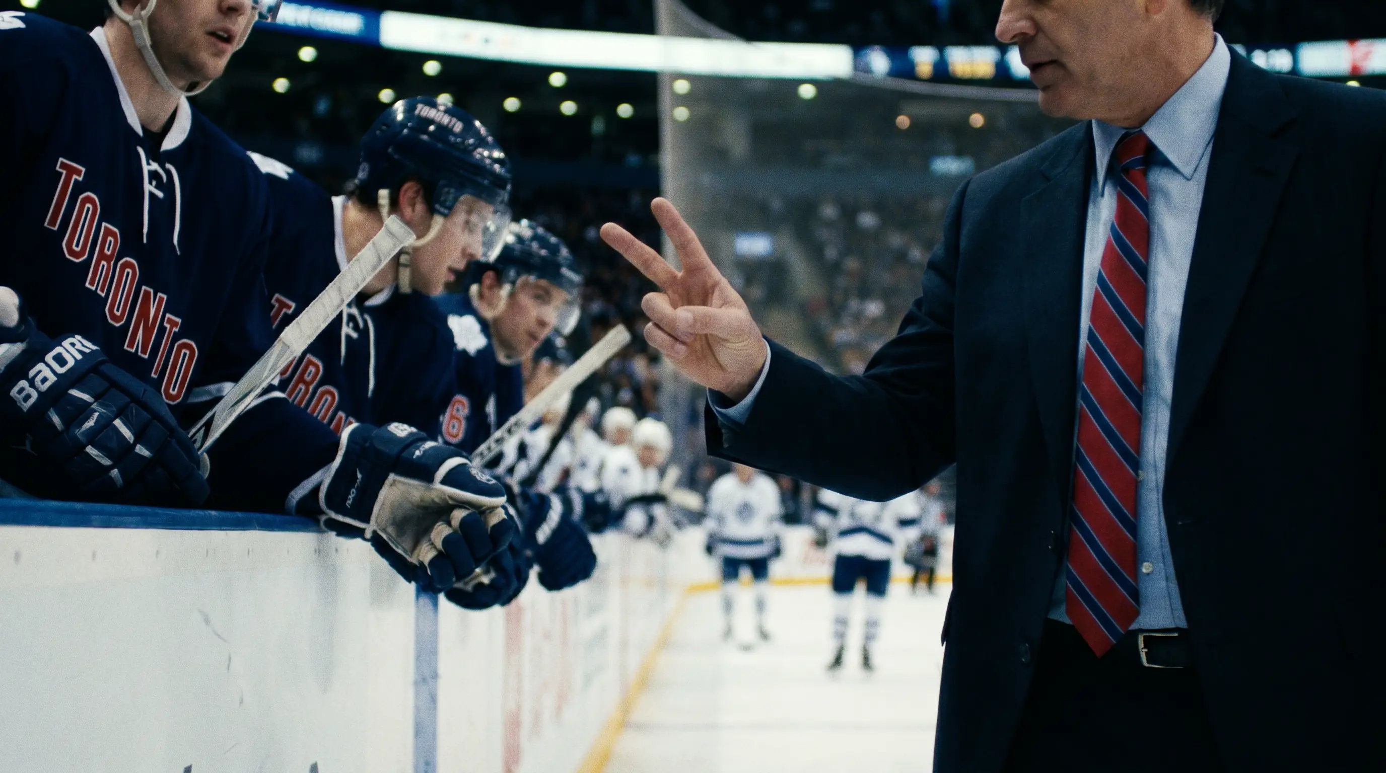 NHL home coach communicating with the bench during a stoppage to deploy the last-change advantage