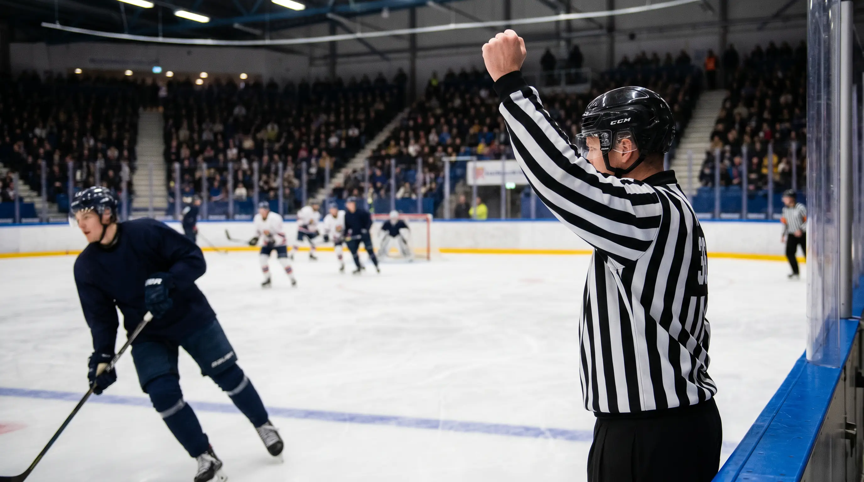 NHL referee signalling a penalty during a fast-paced second period